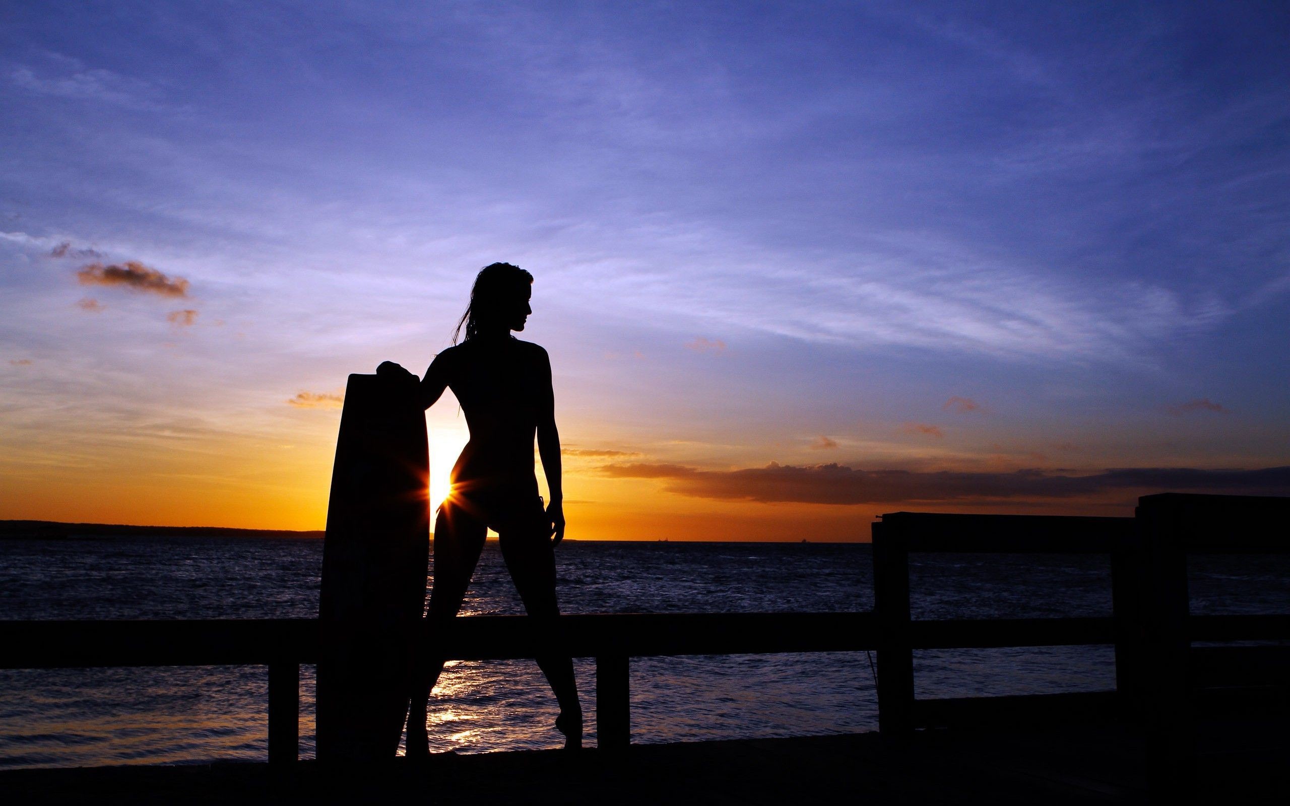 … Woman surfer in the sunset