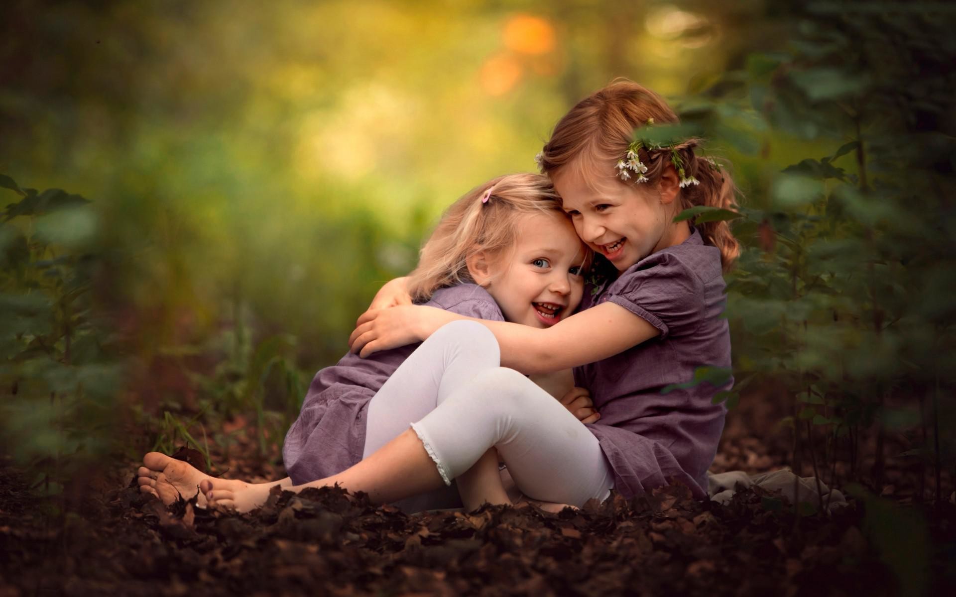 Cute sisters lovingly hugging.