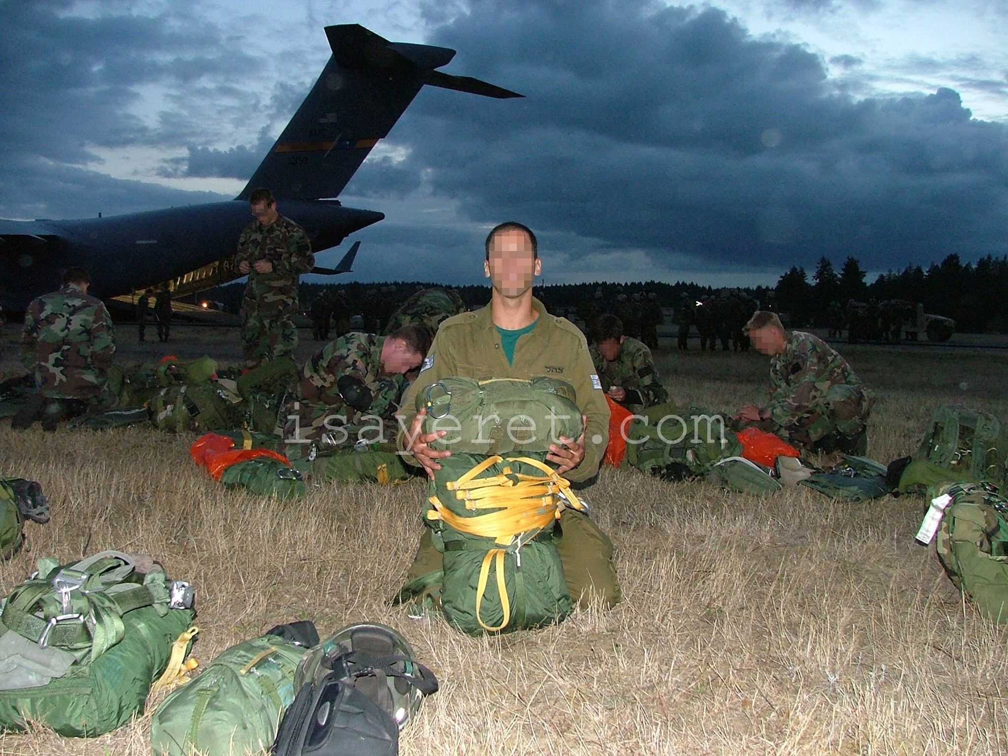 YAHALOM operator (foreground) and U.S. Army Special Forces operators  (background) prepare for parachuting during joint training.
