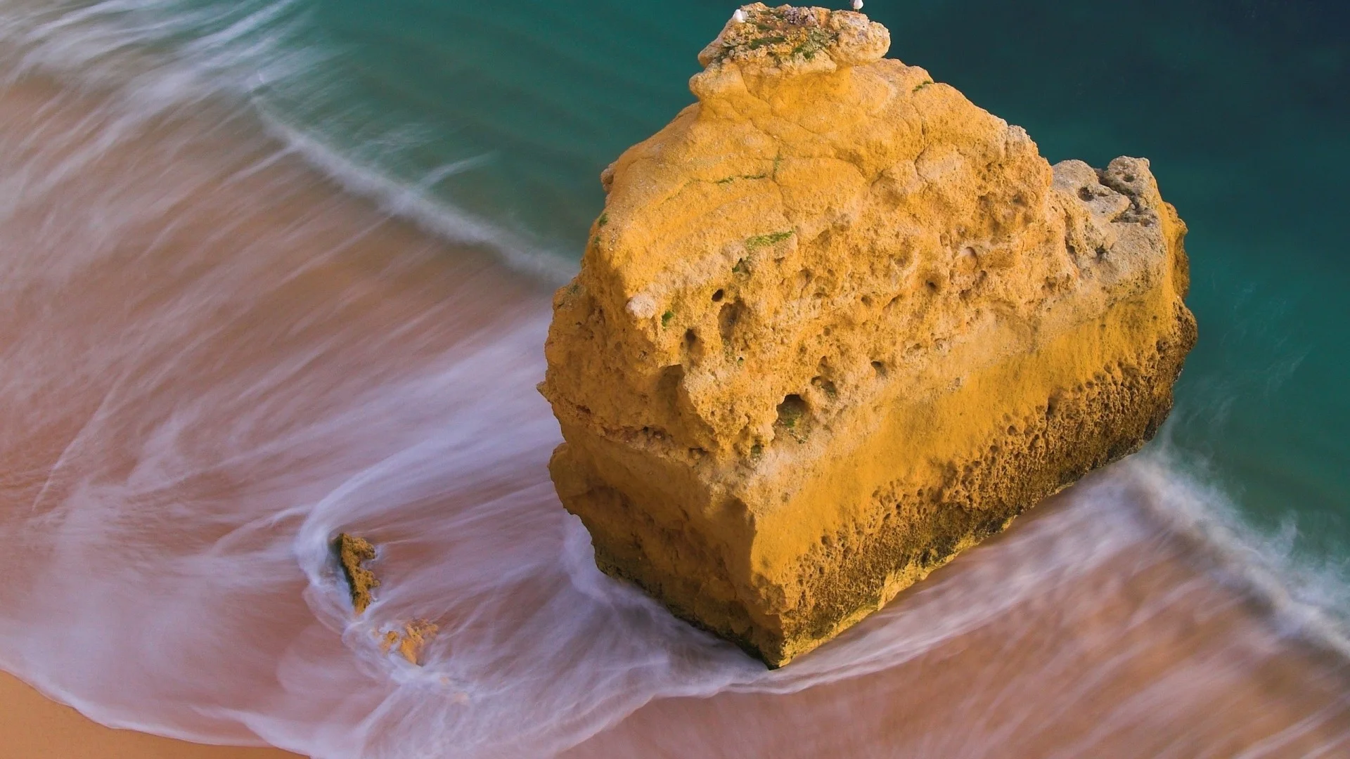 Preview wallpaper ocean, rock, beach, sand 1920×1080
