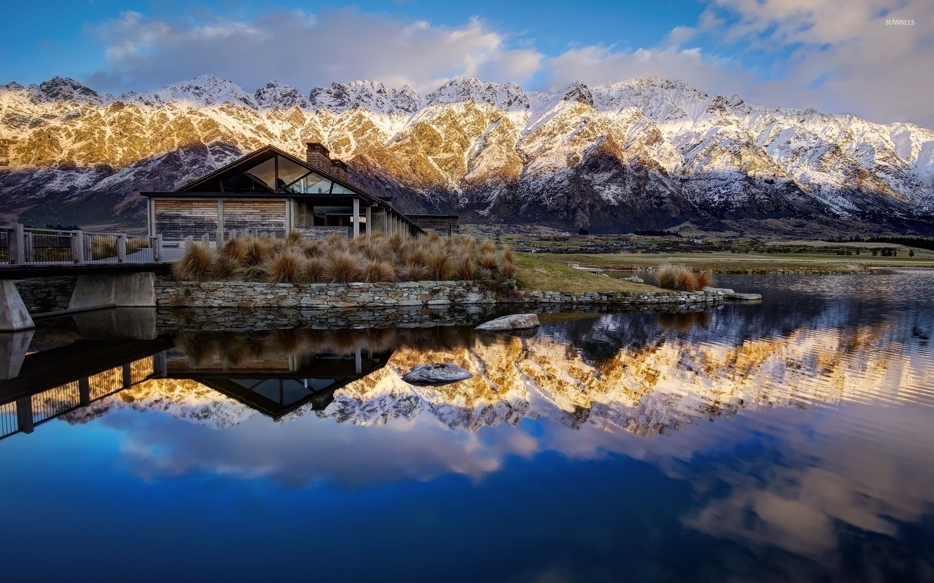 Amazing mountain view behind the hut by the lake wallpaper