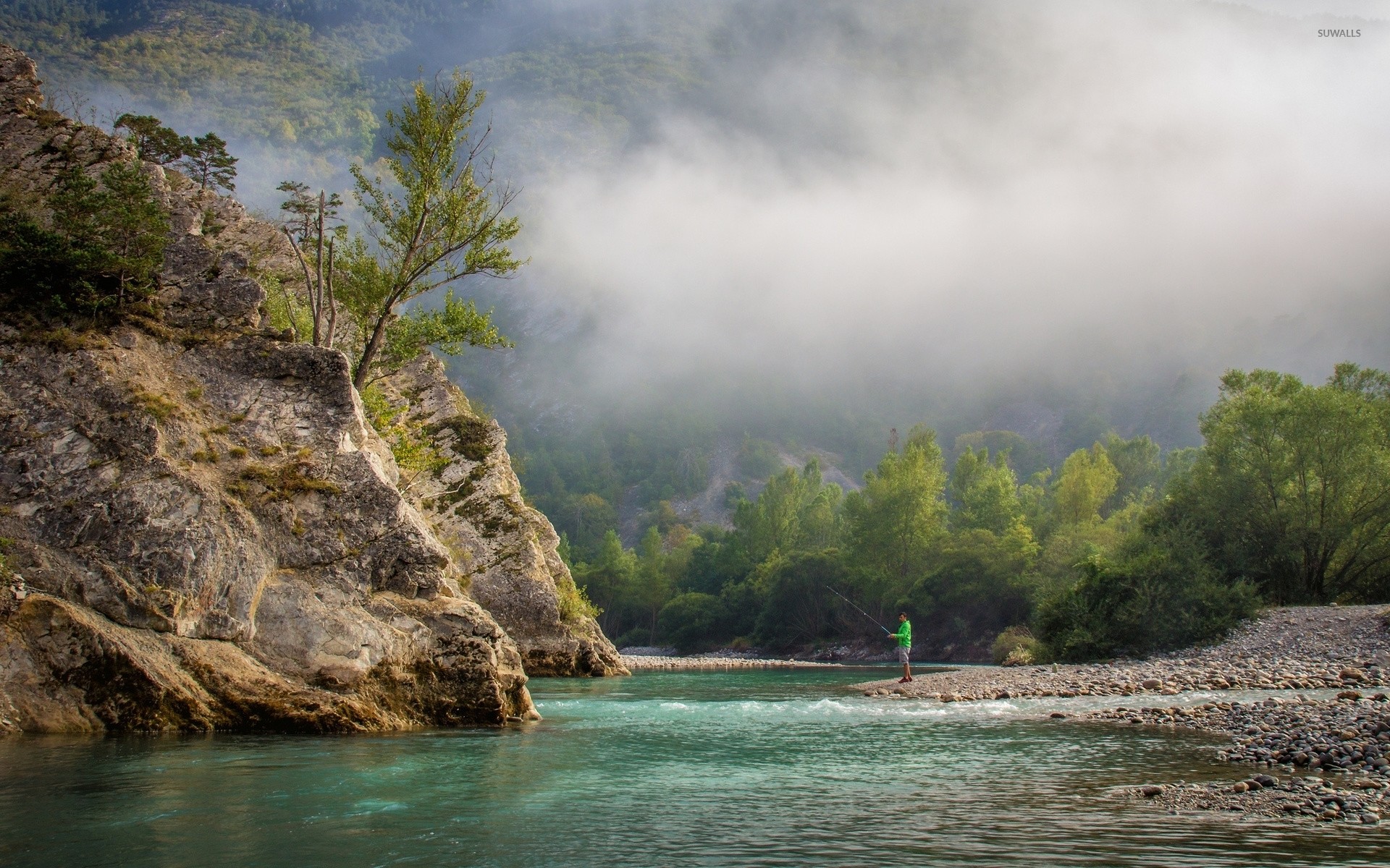 Fishing near the foggy forest mountain wallpaper