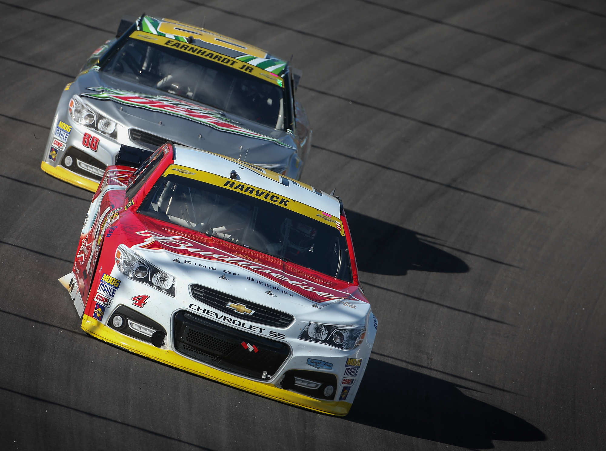 Kevin Harvick leads Dale Earnhardt Jr. at Kansas in 2014. Harold Hinson /