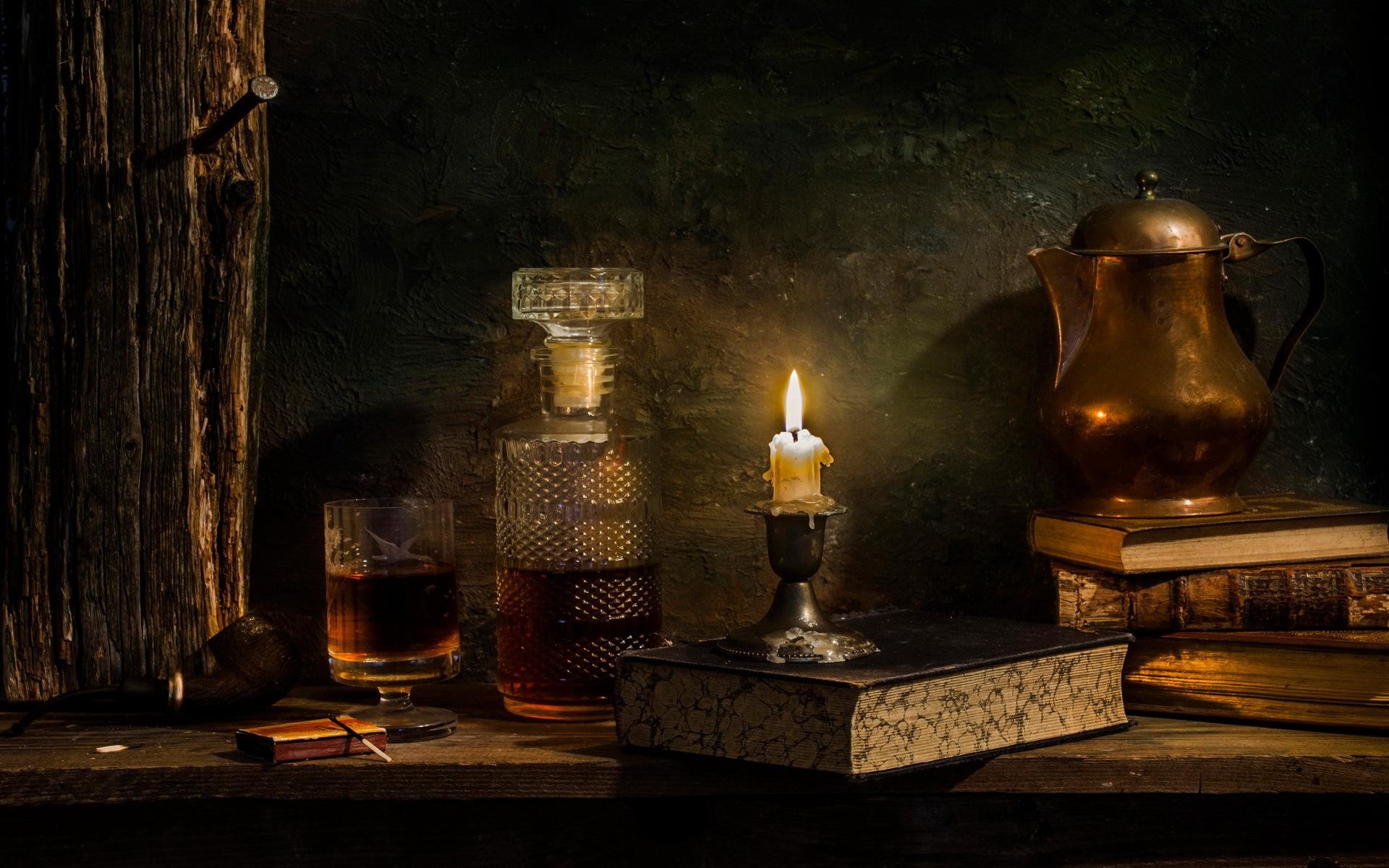 Burning candle near the whisky