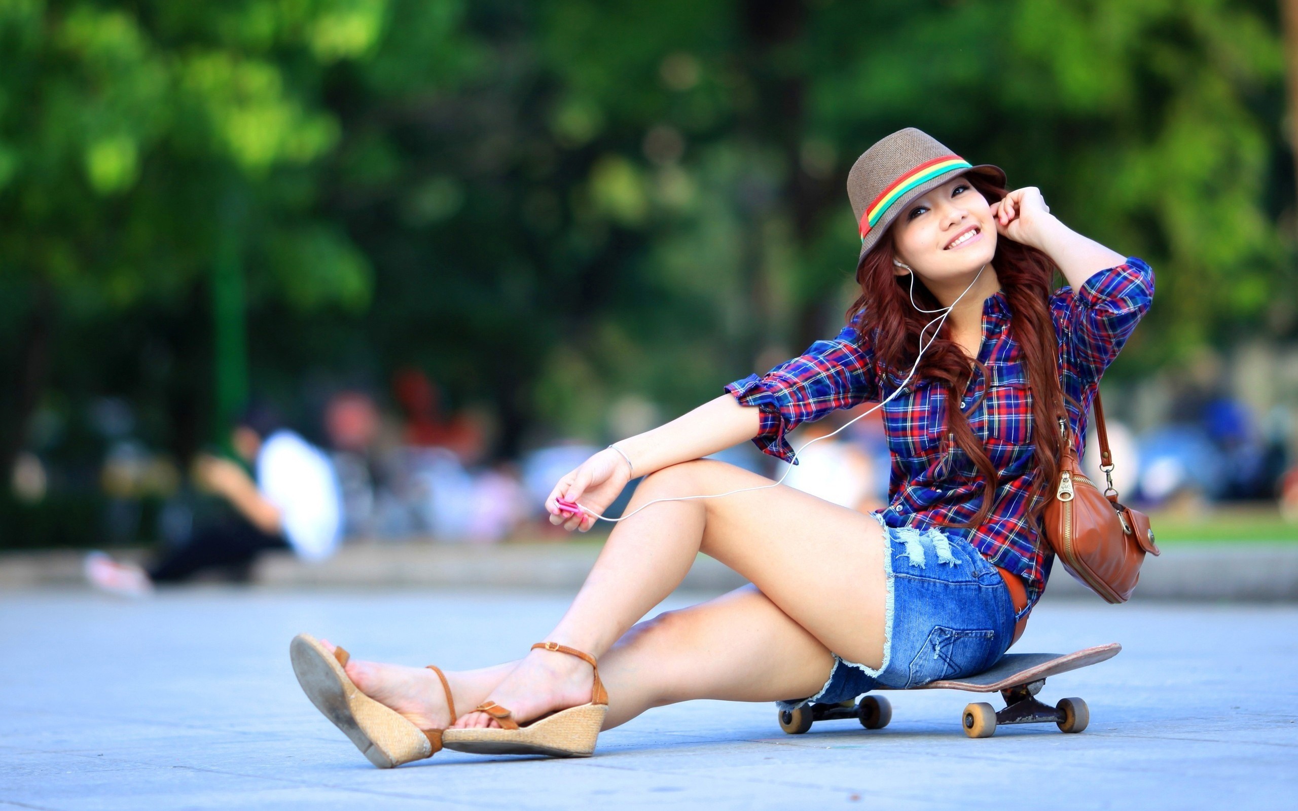 Girl sitting on a skateboard