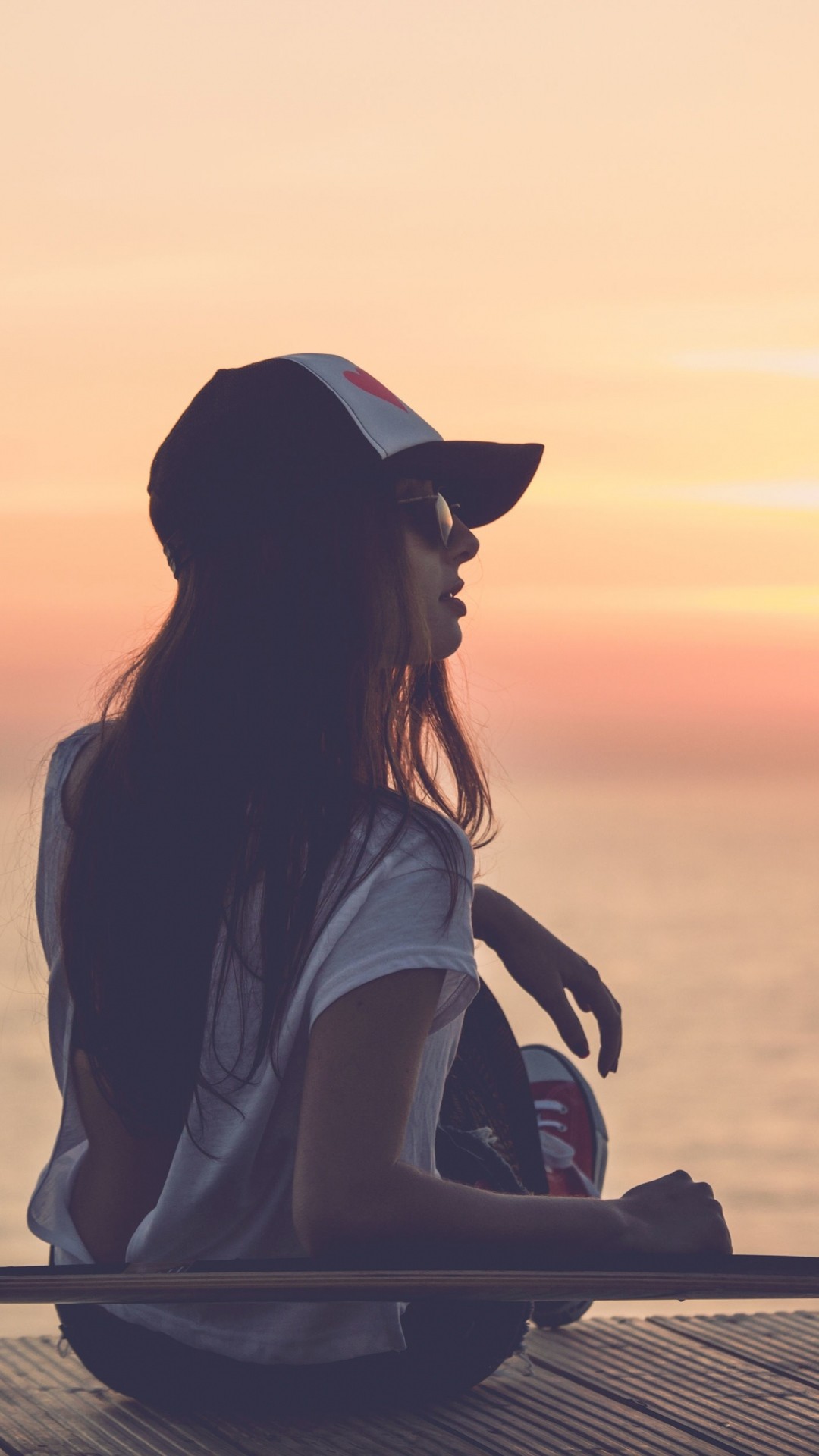 Preview wallpaper girl, skate, sea, sunset, cap 1080×1920