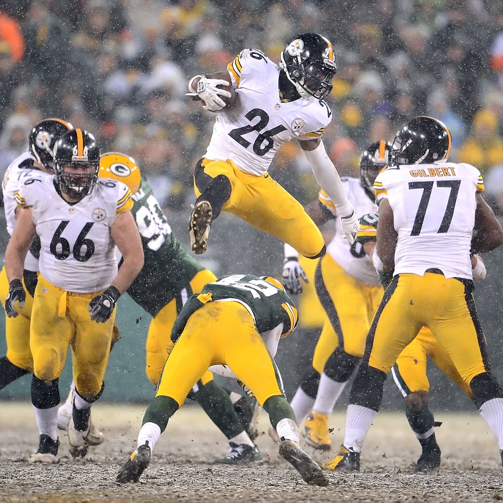 Steelers Le'Veon Bell leaps over Packers Morgan Burnett for first down  yardage in the third quarter at Lambeau Field.