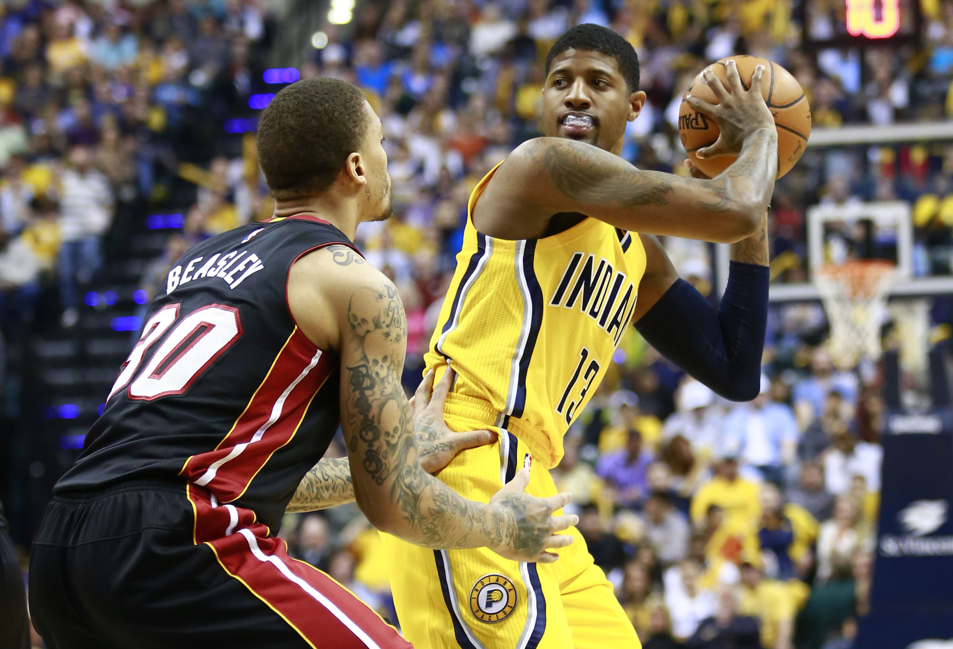 Back in the saddle: Pacers forward Paul George is defended by the Heat's  Michael Beasley