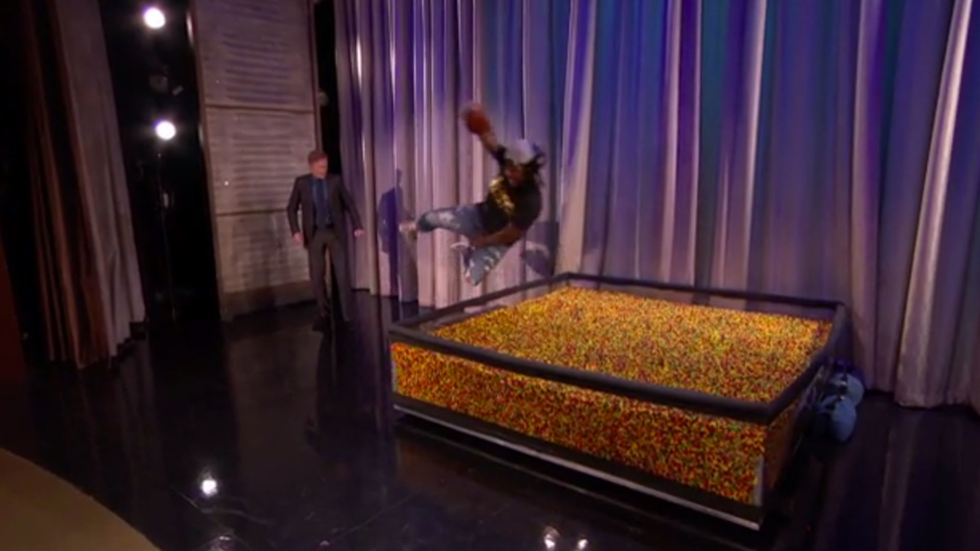 Marshawn Lynch dives into an end zone of Skittles on Conan NFL Sporting News