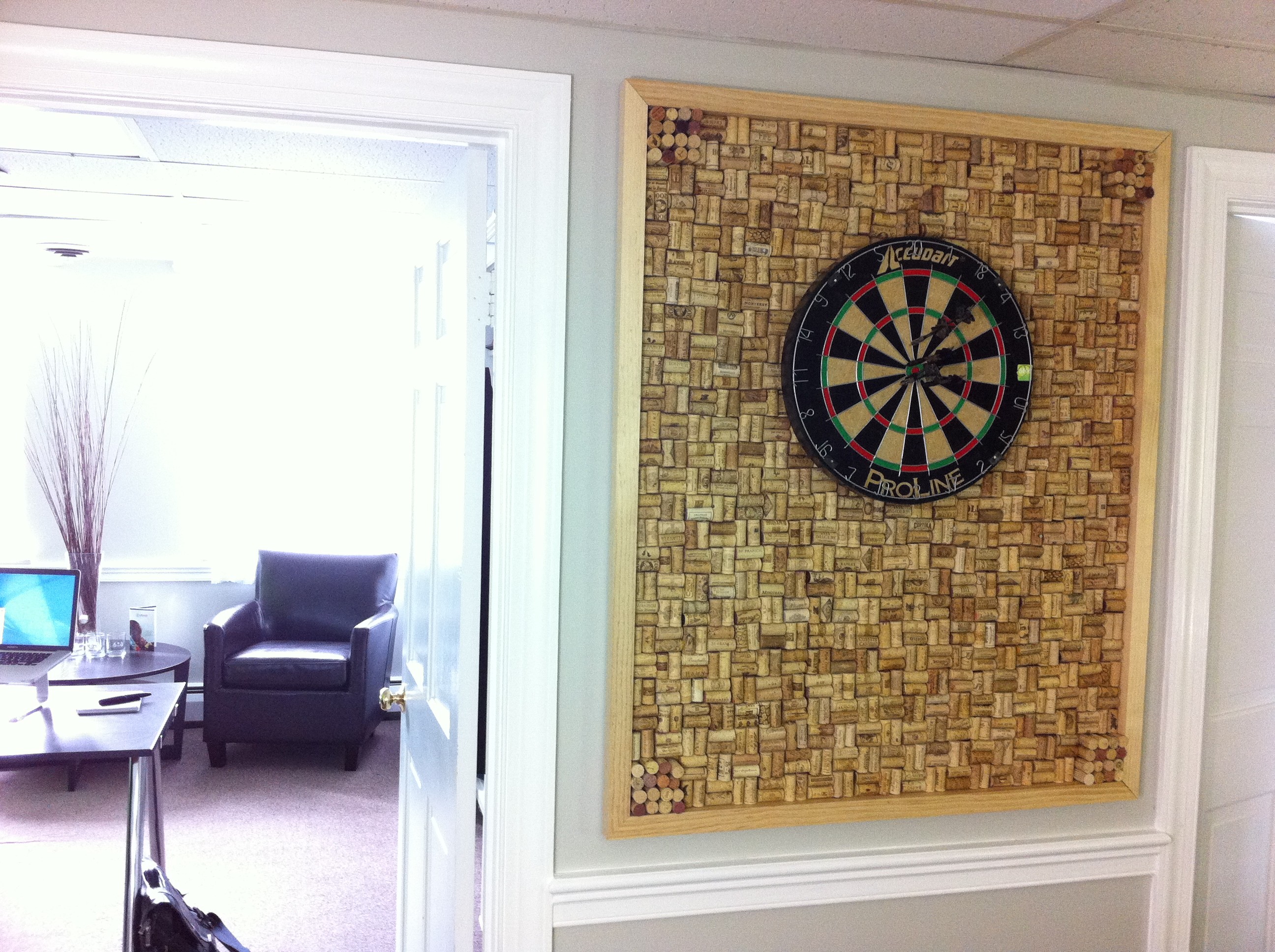 Custom dart board frame with wine cork backing, located in our design studio for brainstorming meetings at www.sixhalfdozen.com Creativity Pinterest