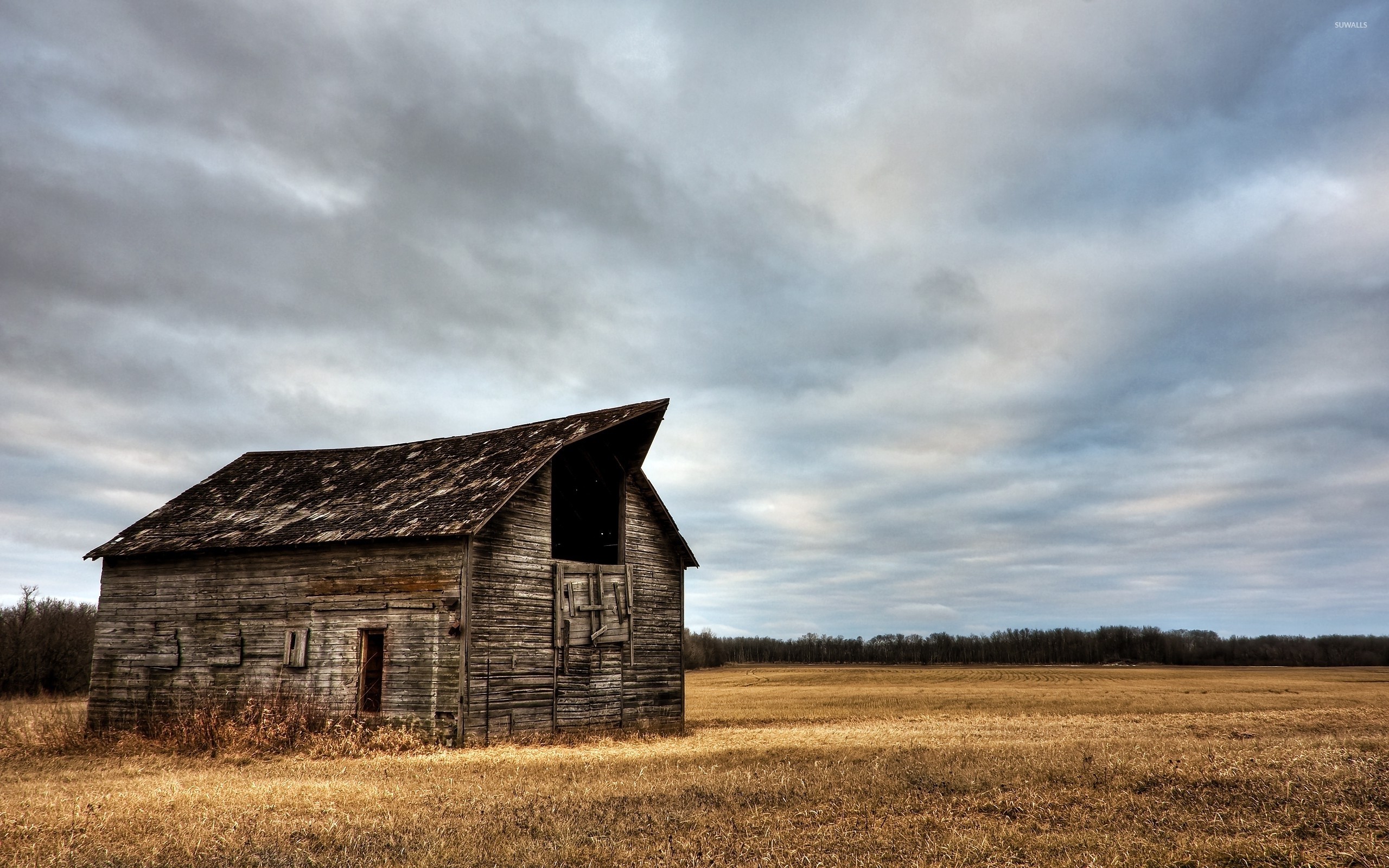 Abandoned wooden barn on a clouded day wallpaper jpg